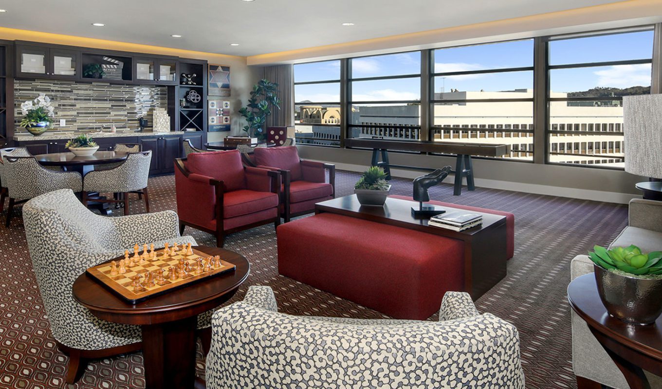 Burbank entertainment lounge with seating areas and chess game on table