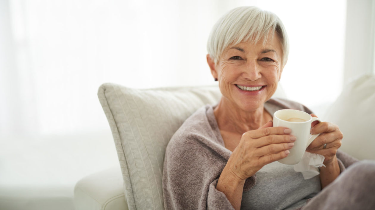 Shot of a senior woman enjoying a relaxing coffee break on the sofa at home.