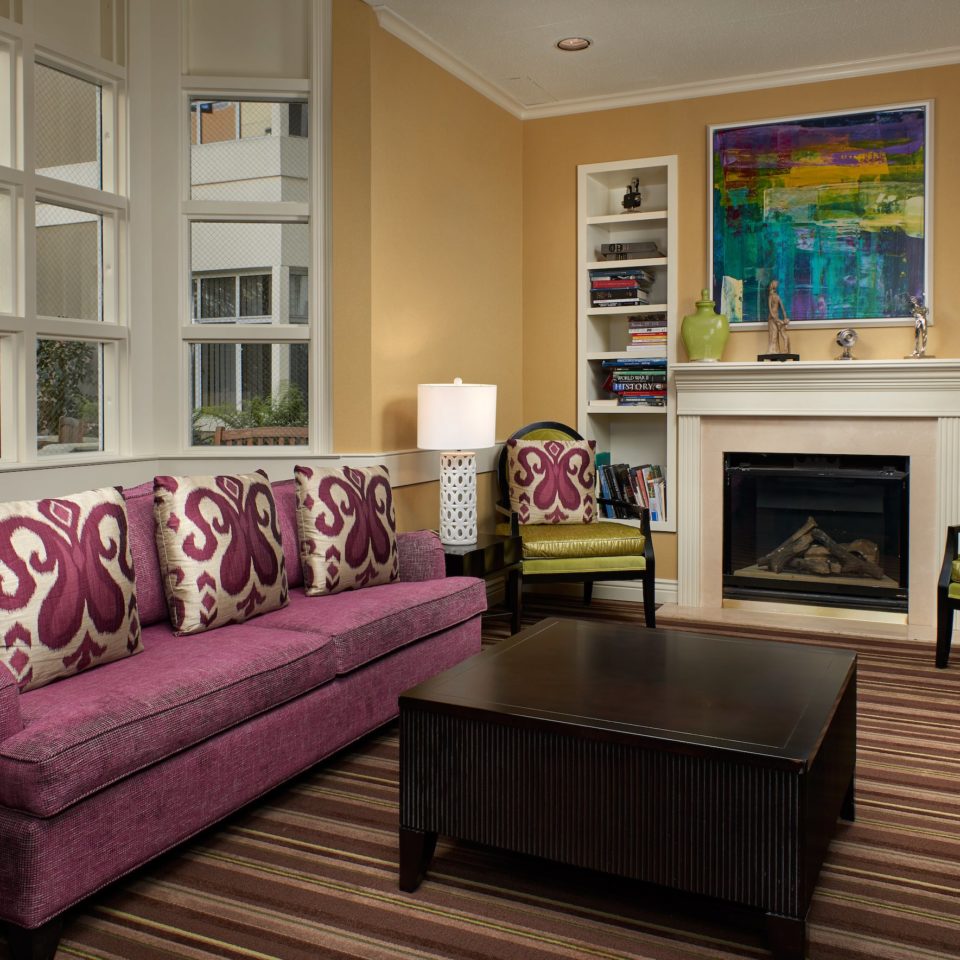 Cathedral Hill family room with a purple couch and fireplace.