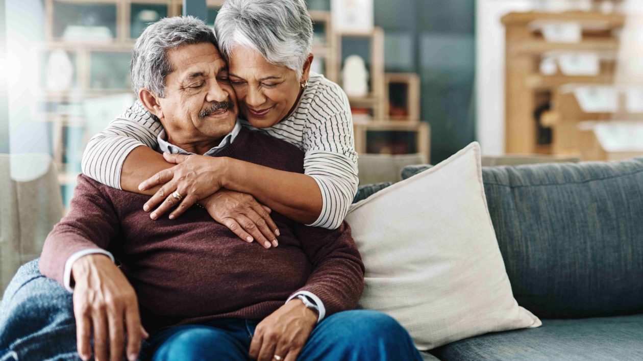 A cheerful woman hugging her husband.