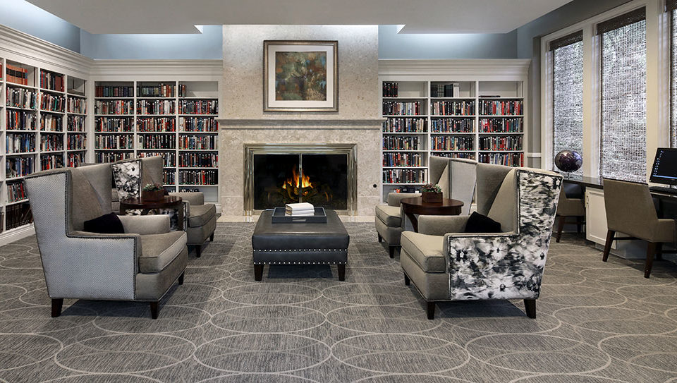 Laguna Woods library with seating area and fire place