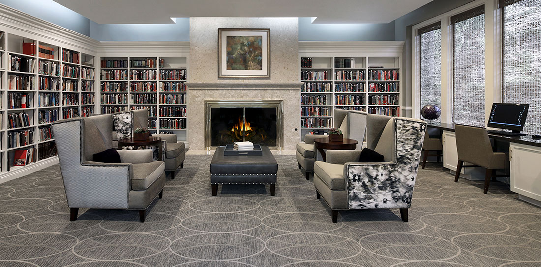 Laguna Woods library with seating area and fire place