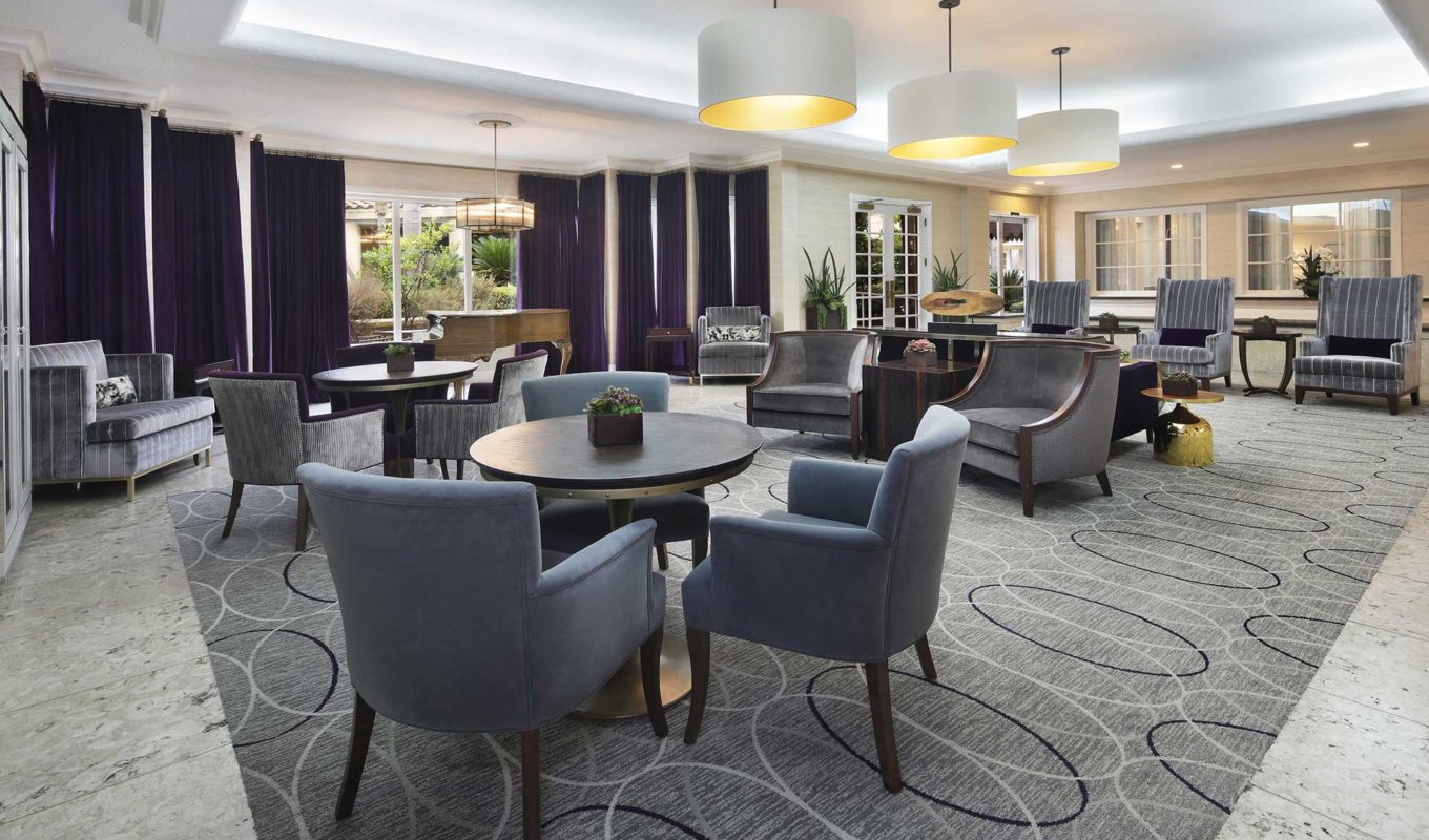 Laguna Woods lounge with seating area and piano