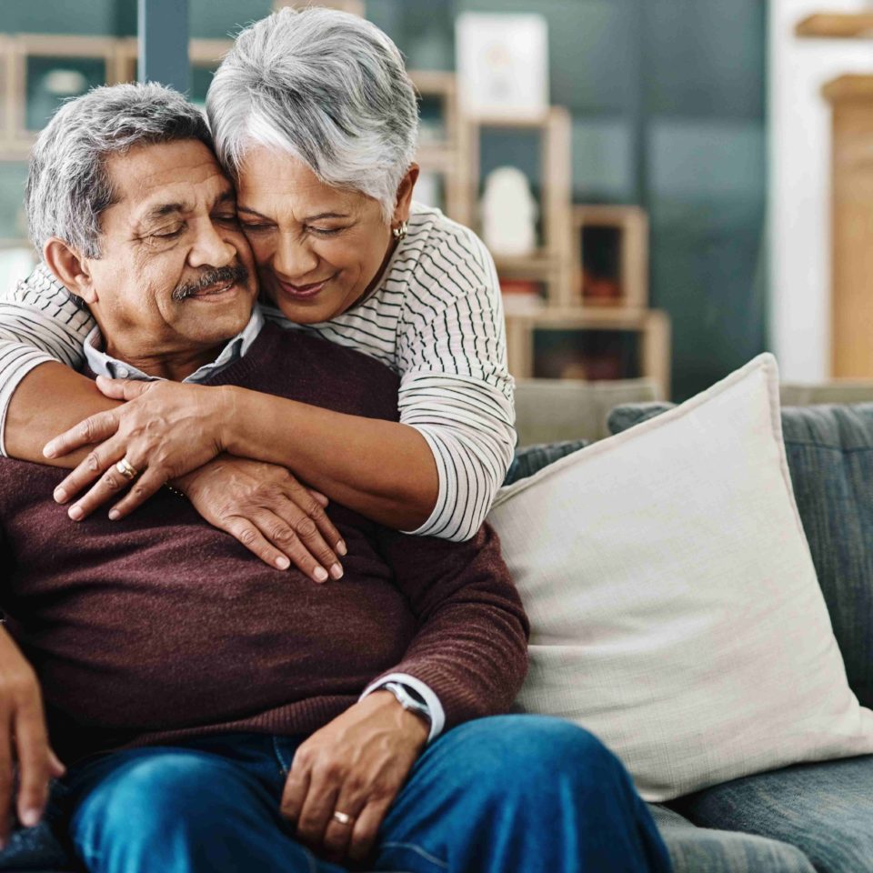 A cheerful woman hugging her husband.