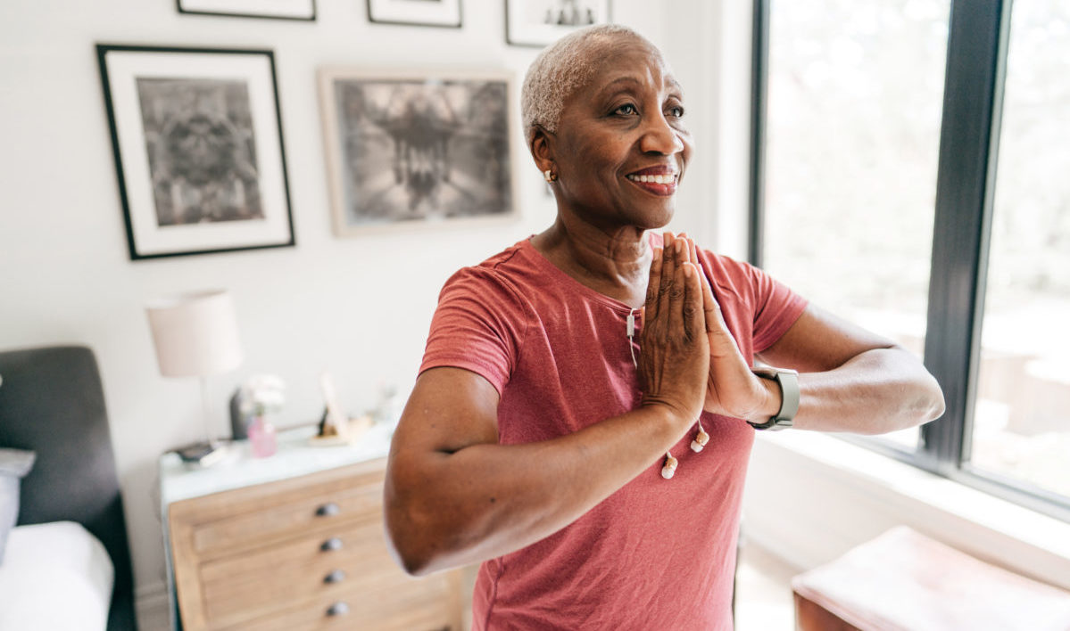 Senior woman exercising at home in sportswear