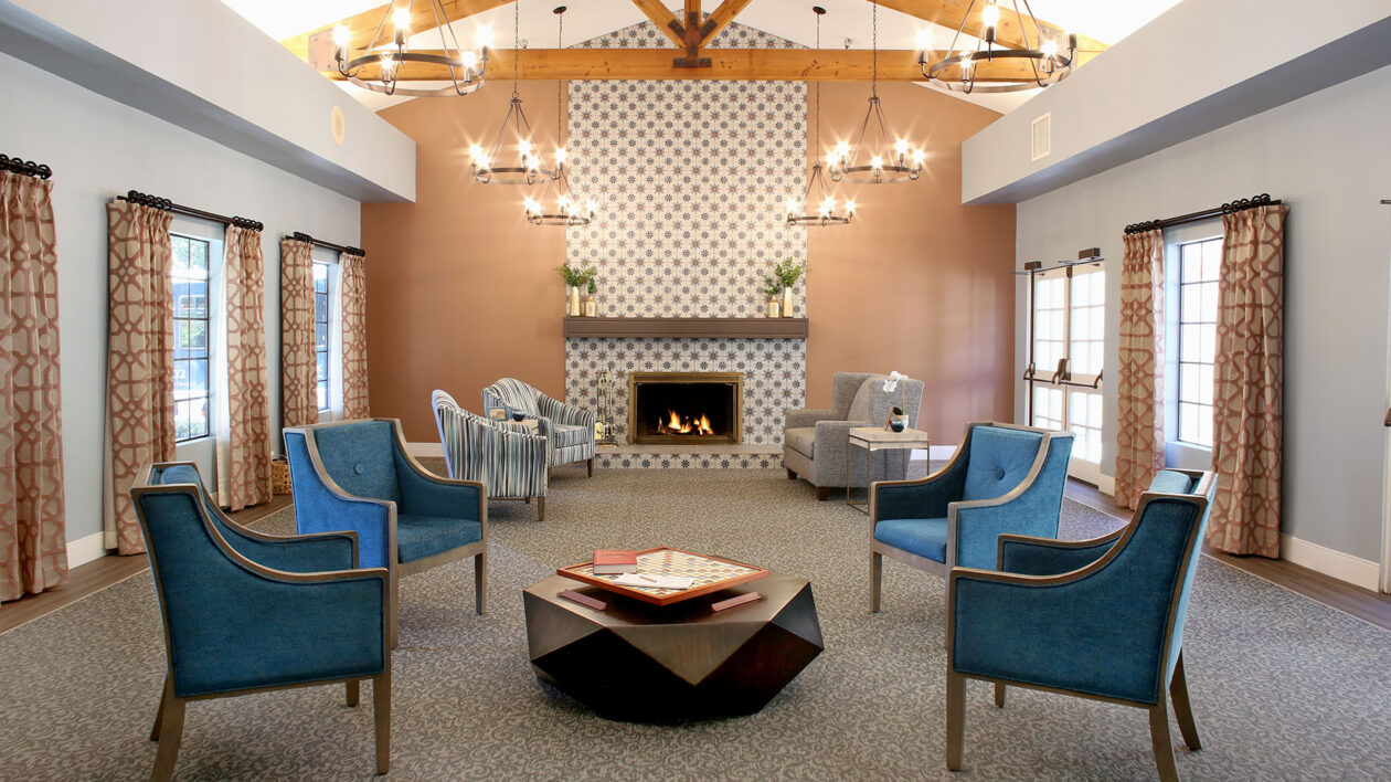 A photo of a lounge and fireplace that seats seven comfortably.
