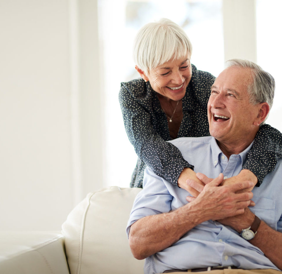 Happy and smiling senior couple embracing.