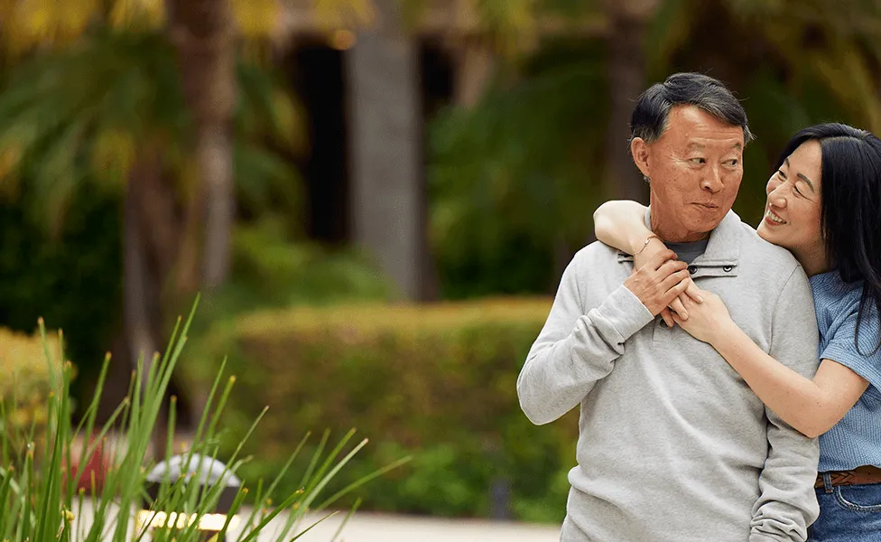 family hugging in park