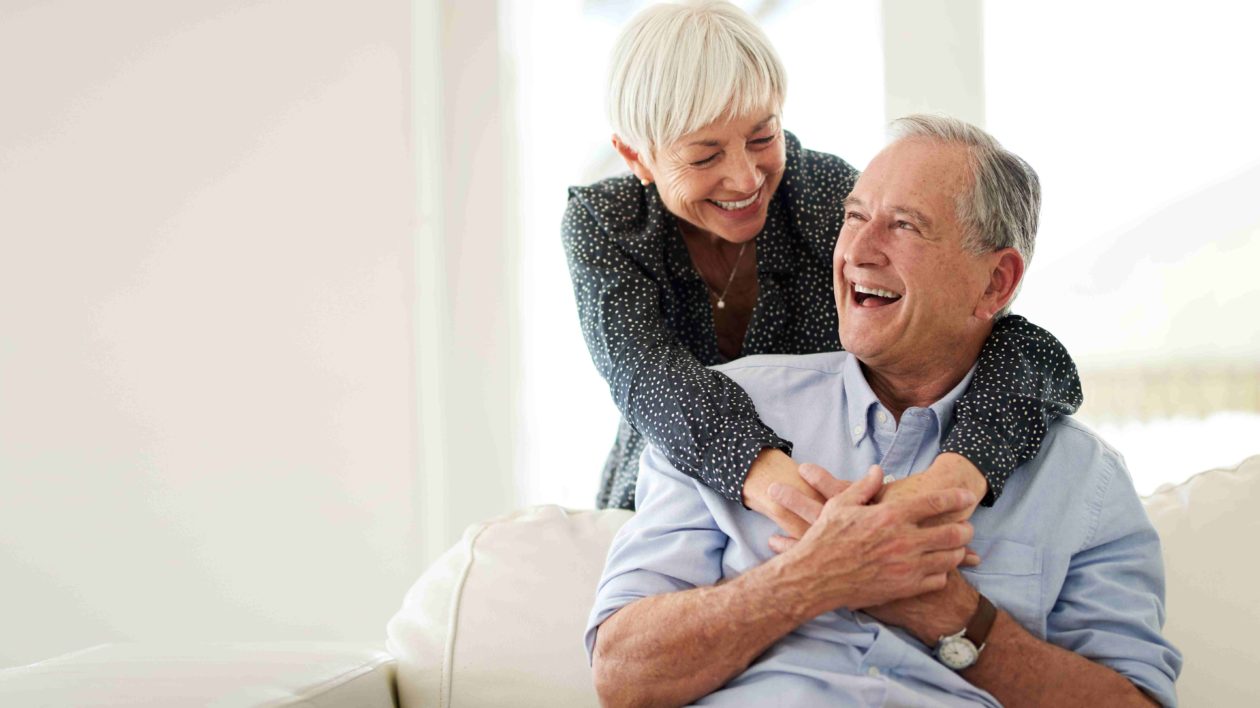 Happy and smiling senior couple embracing