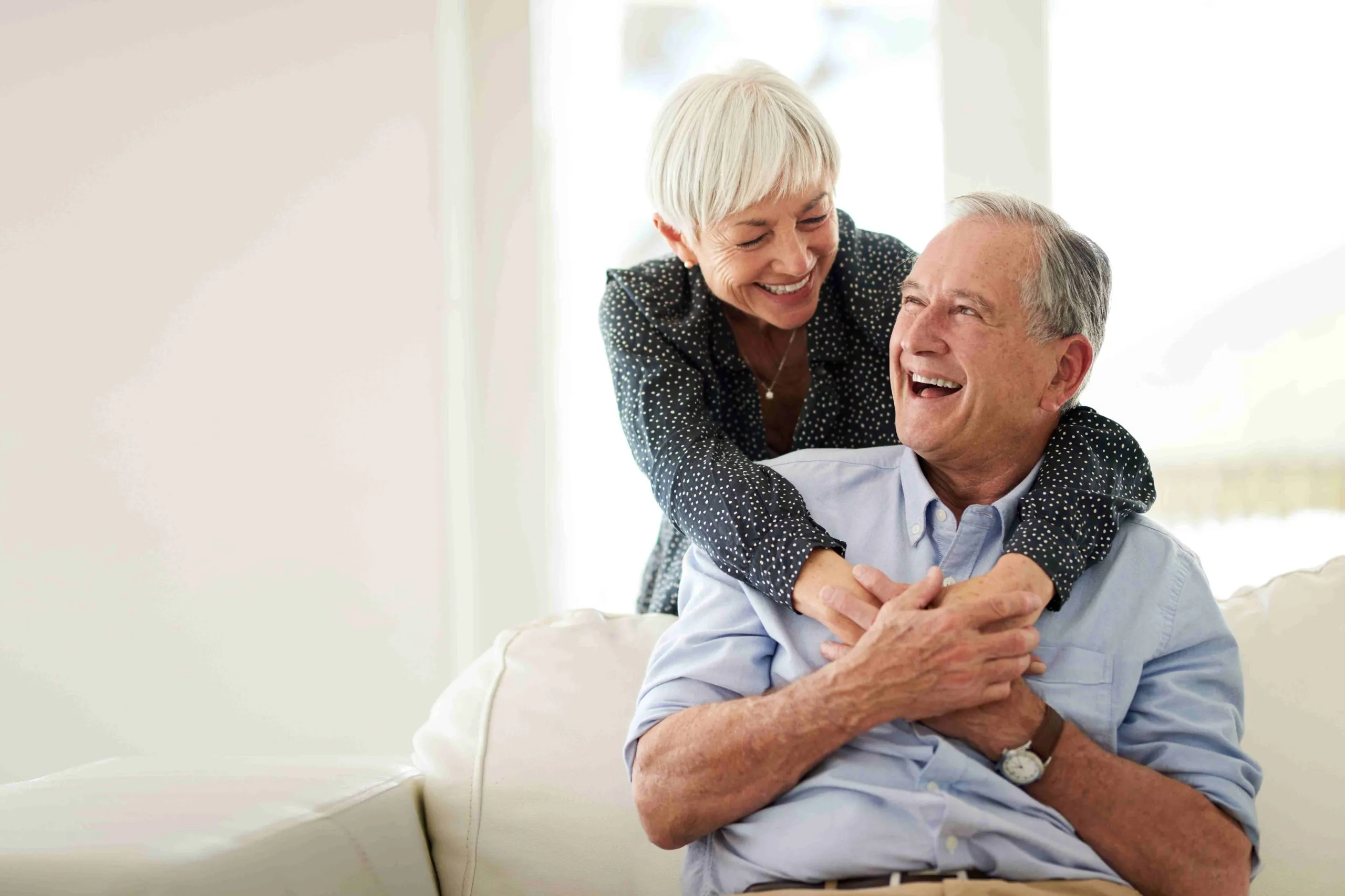 Happy and smiling senior couple embracing