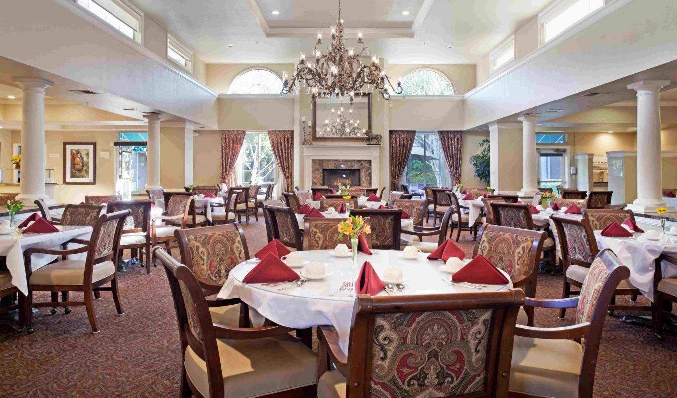 Ivy Park at San Ramon dining room, with rows of decorated tables and a chandelier.