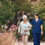Senior walking with staff, trees and flowers in the background.