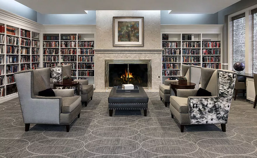 living room area with fireplace and book shelves