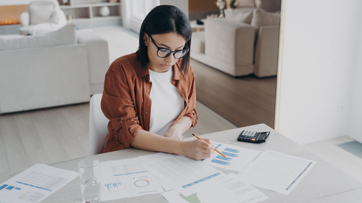 woman-working-on-charts-in-living-room