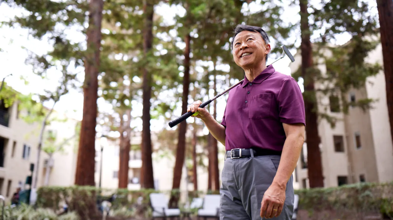 senior-man-smiling-playing-golf-outside
