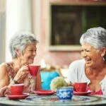 senior-ladies-having-coffee-together-and-laughing