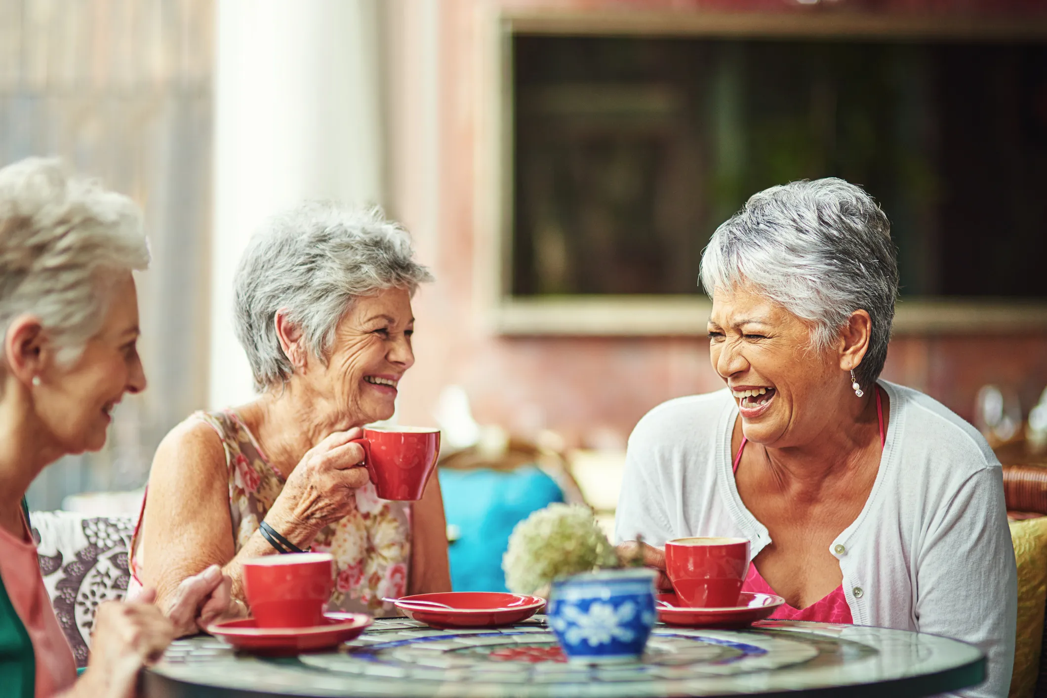 senior-ladies-having-coffee-together-and-laughing