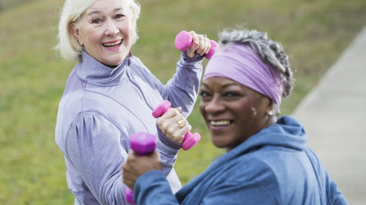 2-senior-ladies-smiling-and-exercising-in-a-park