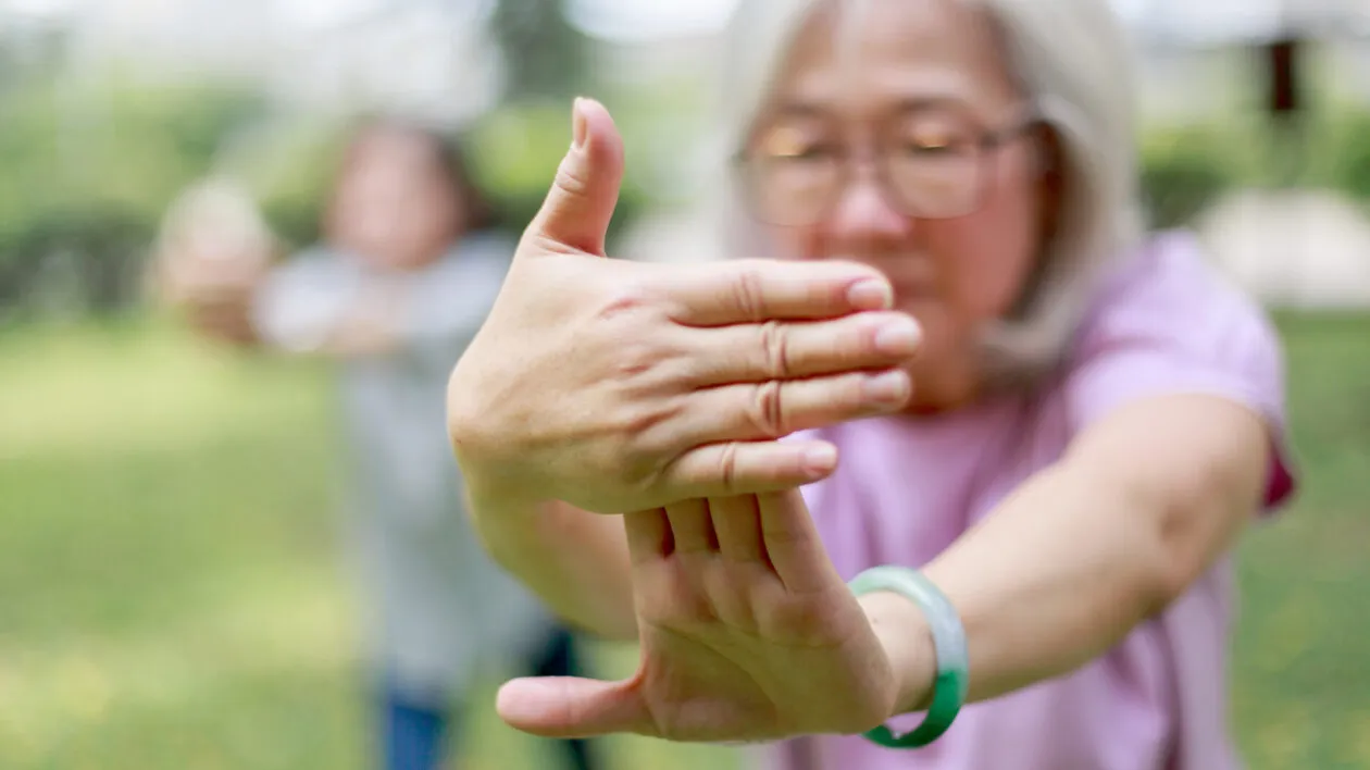 senior-lady-exercising-in-a-park-with-tai-chi