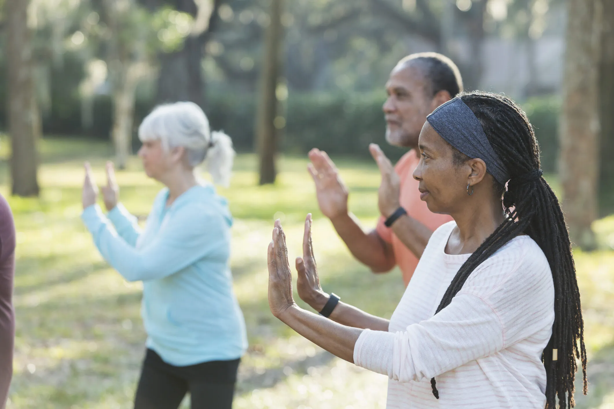 seniors-in-a-park-excercising-with-tai-chi-class