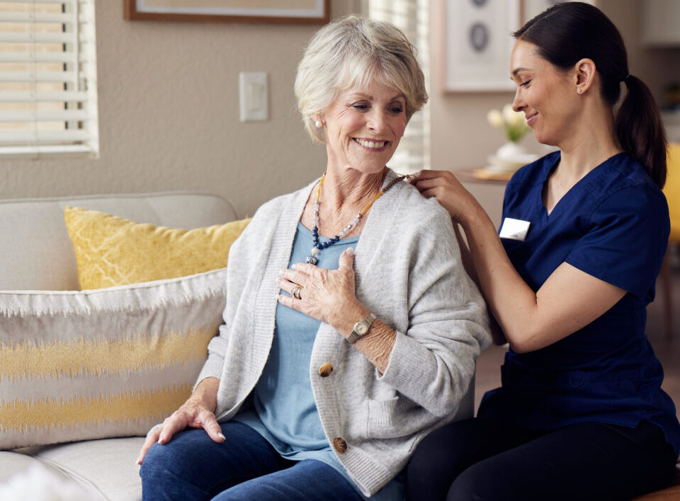 Senior woman receiving attentive care from a nurse at a senior living community